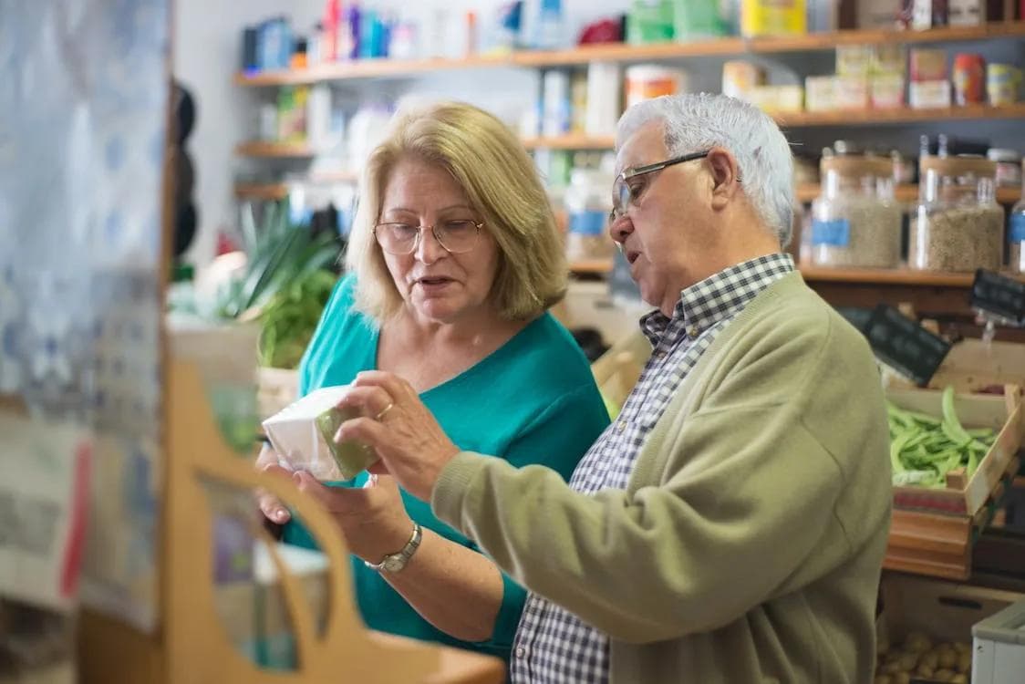Elderly couple reading food labels