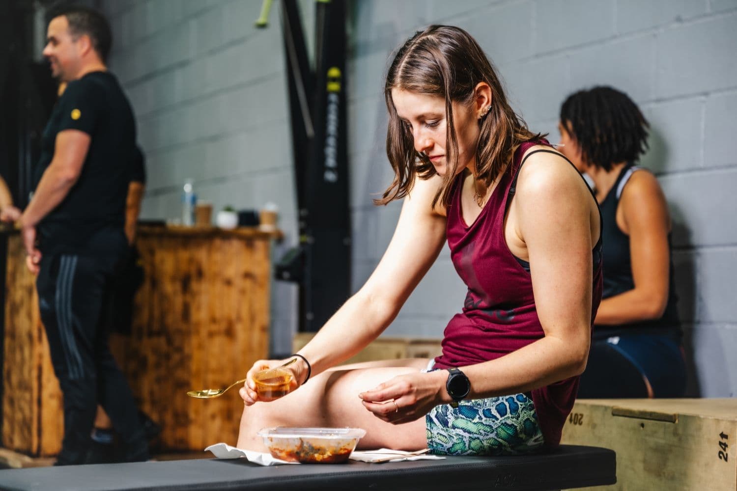 Woman eating Prep Kitchen meal at the gym